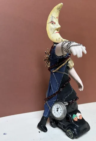 Deity talisman for Mani - found objects, jewelry, ceramics, cloth and clay, approx. 24 x 12 x 10 cm Deity statue made from found objects and jewelry. Representing Mani, the moon as guide in dreams and visions